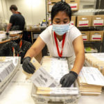 
              An election worker processes mail-in-ballots for the midterm election at the Riverside County Registrar-Voter in Riverside, Calif., on Thursday, Nov. 10, 2022. (Watchara Phomicinda/The Orange County Register via AP)
            