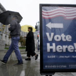 
              People carry umbrellas while walking past a voting sign outside City Hall in San Francisco, Tuesday, Nov. 8, 2022. A major winter storm pounded California on Tuesday, bringing rain and snow to the drought-stricken state along with possible flash flooding in areas recently scarred by wildfires, meteorologists said. (AP Photo/Jeff Chiu)
            