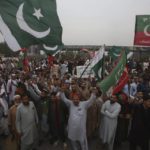 
              Supporters of former Pakistani Prime Minister Imran Khan's party, 'Pakistan Tehreek-e-Insaf' chant slogans while they block a highway during a protest to condemn a shooting incident on their leader's convoy, in Peshawar, Pakistan, Friday, Nov. 4, 2022. Khan who narrowly escaped an assassination attempt on his life the previous day when a gunman fired multiple shots and wounded him in the leg during a protest rally is listed in stable condition after undergoing surgery at a hospital, a senior leader from his party said Friday. (AP Photo/Muhammad Sajjad)
            