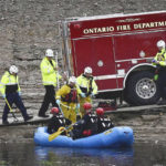 
              A swift water rescue team from the Ontario Fire Dept. rides in a raft on flood waters in a flood control channel in Ontario, Calif. on Tuesday, Nov. 8, 2022. (Watchara Phomicinda/The Orange County Register via AP)
            