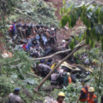 
              Rescuers remove the wreckages of vehicles damaged in an earthquake-triggered landslide in Cianjur, West Java, Indonesia, Monday, Nov. 21, 2022. The strong, shallow earthquake toppled buildings and collapsed walls on Indonesia's densely populated main island of Java on Monday, killing a number of people and injuring hundreds as people rushed into the streets, some covered in blood and white debris. (AP Photo/Rangga Firmansyah)
            