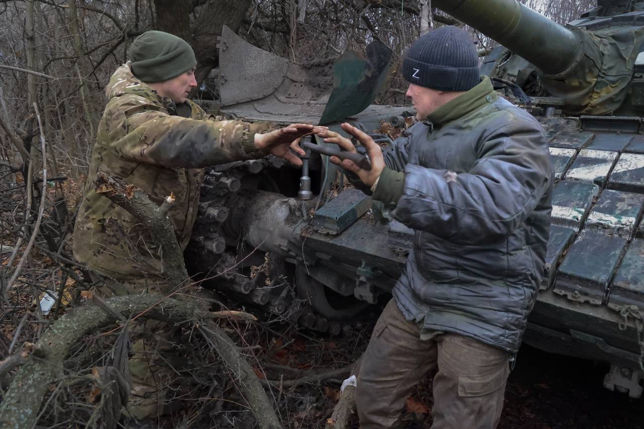 Servicemen of the People’s Militia of Russian-controlled Donetsk region repair a T-72 tank damage...