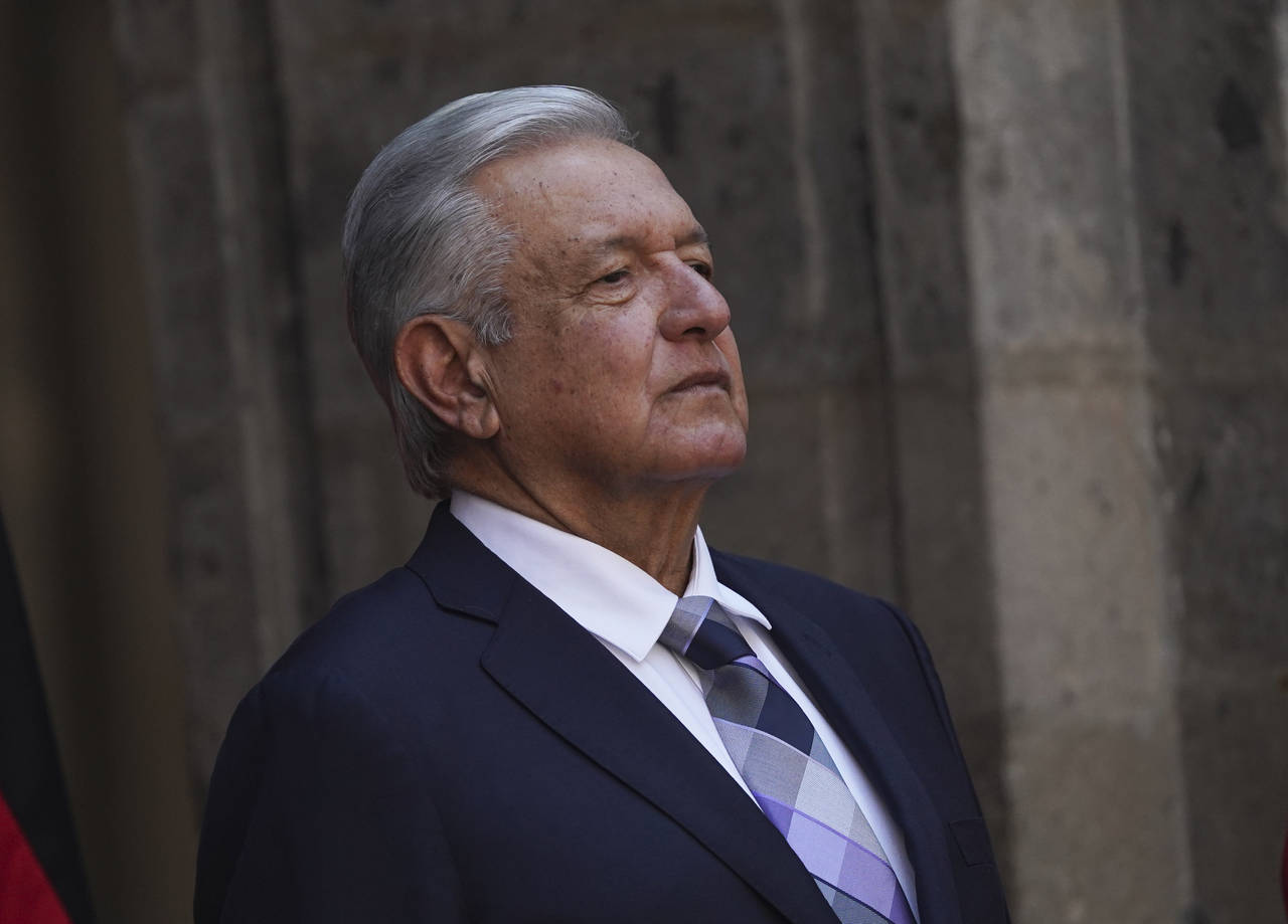 FILE - Mexican President Andres Lopez Obrador stands at the National Palace during a welcome ceremo...