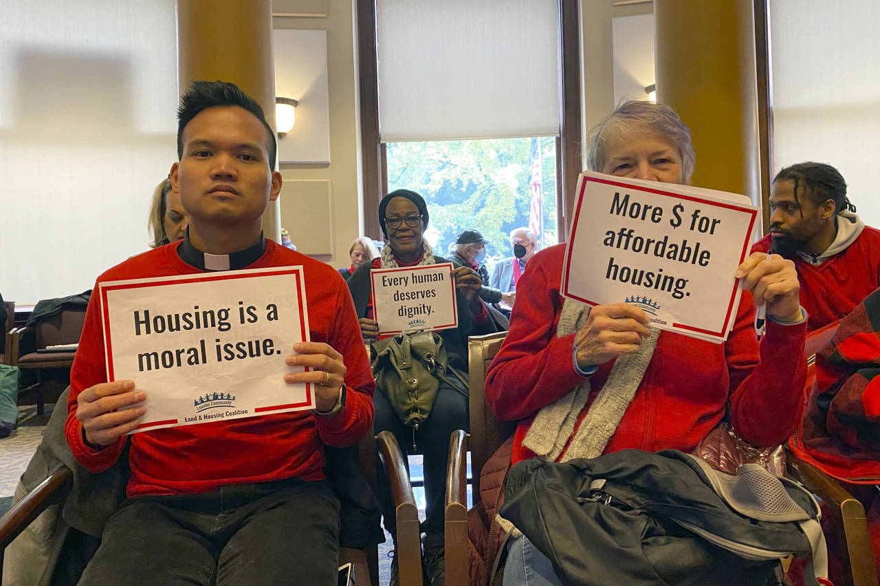 Members of the Leaven Community Land & Housing Coalition attend a Portland City Council Meeting on ...
