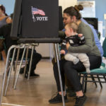 
              Miranda Padilla holds her 11-month-old son Grayson Sanchez while marking her ballot at a polling center in the South Valley area of Albuquerque, N.M., Tuesday, Nov. 8, 2022 (AP Photo/Andres Leighton)
            