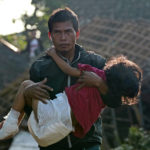 
              A man carries his injured daughter as they head to a temporary shelter for those displaced by Monday's earthquake in Cianjur, West Java, Indonesia, Thursday, Nov. 24, 2022. The 5.6 magnitude earthquake left hundreds dead, injures and missing as buildings crumbled and terrified residents ran for their lives on Indonesia's main island of Java. (AP Photo/Tatan Syuflana)
            