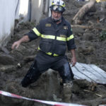 
              A firefighter walks after heavy rainfall triggered landslides that collapsed buildings, in Casamicciola, on the southern Italian island of Ischia, Monday, Nov. 28, 2022. Authorities said that the landslide that early Saturday destroyed buildings and swept parked cars into the sea left seven people dead and 5 missing. (AP Photo/Salvatore Laporta)
            