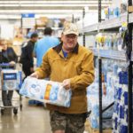 
              John Beezley, of Bonham, buys cases of water after learning that a boil water notice was issued for the entire city of Houston on Sunday, Nov. 27, 2022, at Walmart on S. Post Oak Road in Houston. Beezley just arrived in town with his wife, who is undergoing treatment starting tomorrow at M.D. Anderson Cancer Center, where they are staying in a camping trailer. They turned on the television after settling in and saw that a boil water notice had been issued. Beezley decided to go out immediately fearing that by tomorrow people would be buying up all of the available water. (Mark Mulligan/Houston Chronicle via AP)
            