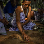 
              Village chieftain Gasia Maranda performs rituals as he along with other tribals worship inside an enclosure at a sacred grove believed to be the home of the village goddess, in village Guduta, in the eastern Indian state of Odisha, Oct. 21, 2022. Maranda and others in Guduta, a remote tribal village in India's eastern Odisha state that rests in a seemingly endless forest landscape, adhere to Sarna Dharma - a faith not officially recognized by the government. It is a belief system that shares common threads with the world's many ancient nature-worshipping religions. (AP Photo/Altaf Qadri)
            