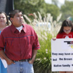 
              FILE - Chebon Kernell, center, an elder in the United Methodist Church and a member of the Seminole Nation, prays at the start of a rally in support of three-year-old baby Veronica, Veronica's biological father, Dusten Brown, and the Indian Child Welfare Act, in Oklahoma City, Monday, Aug. 19, 2013. Brown is trying to maintain custody of the girl who was given up for adoption by her birth mother to a couple in South Carolina. The U.S. Supreme Court says Brown cannot use the Indian Child Welfare Act to press his claims. The U.S. Supreme Court will hear arguments, Wednesday, Nov. 9, 2022 on the most significant challenge to the Indian Child Welfare Act that gives preference to Native American families in foster care and adoption proceedings of Native American children since it passed in 1978. (AP Photo/Sue Ogrocki, File)
            