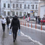 
              Kateryna Luchkina, a 31-year-old worker at Kyiv’s Department of Health, walks away after collecting rainwater from a drainpipe in Kyiv, on Thursday. Nov. 24, 2022. Residents of Ukraine's bombed but not cowed capital roamed the streets with empty bottles in search of water and crowded into cafés for warmth, light and power Thursday, switching defiantly into survival mode after new Russian missile strikes the previous day plunged the city of 3 million and much of the country into the dark in winter. (AP Photo/John Leicester)
            