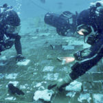 
              In this photo provided by the HISTORY® Channel, underwater explorer and marine biologist Mike Barnette and wreck diver Jimmy Gadomski explore a 20-foot segment of the 1986 Space Shuttle Challenger that the team discovered in the waters off the coast of Florida during the filming of The HISTORY® Channel’s new series, “The Bermuda Triangle: Into Cursed Waters,” premiering Tuesday, Nov. 22, 2022. (The HISTORY® Channel via AP)
            