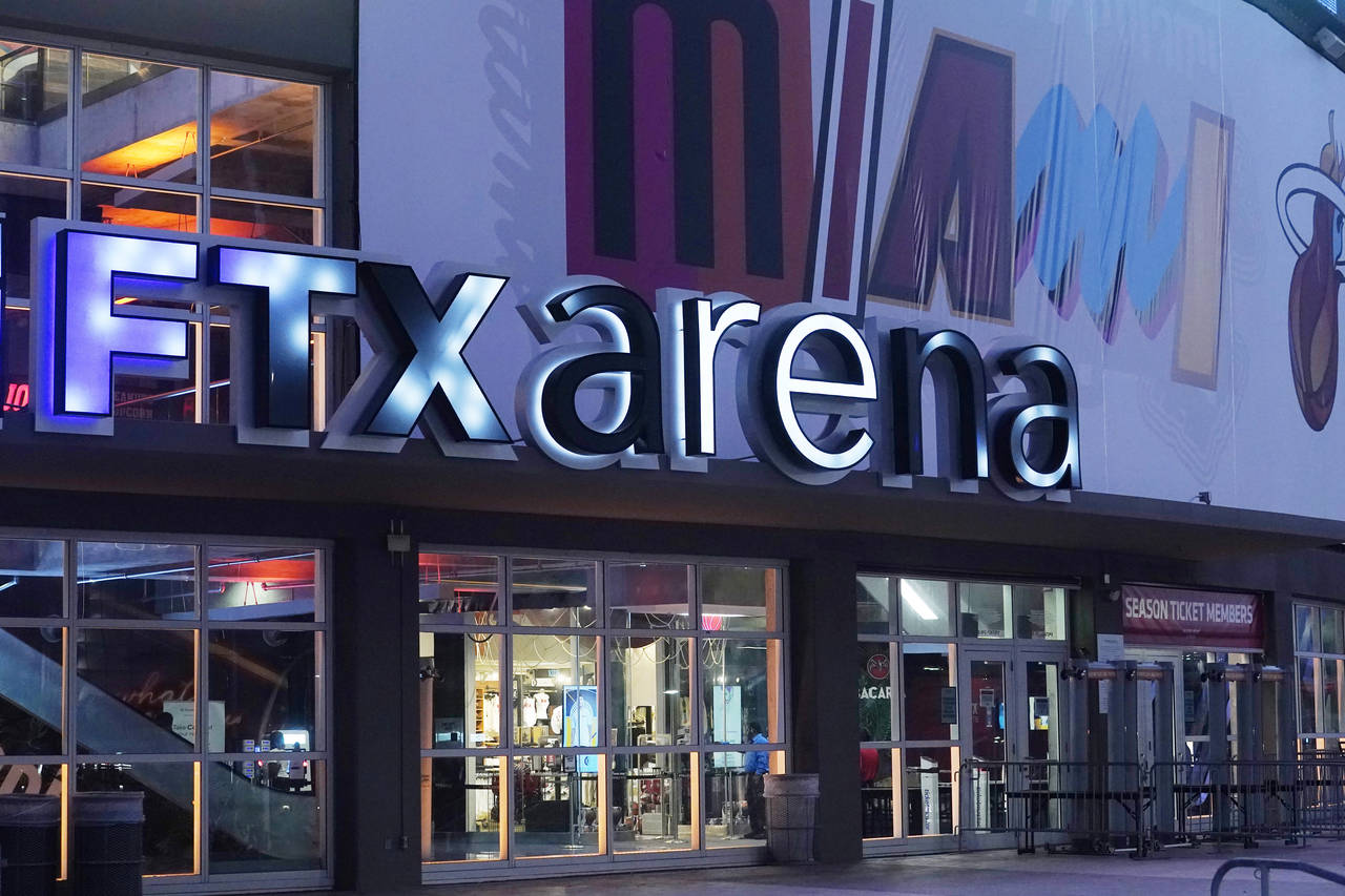 FILE - A sign for the FTX Arena, where the Miami Heat basketball team plays, is illuminated on Nov....