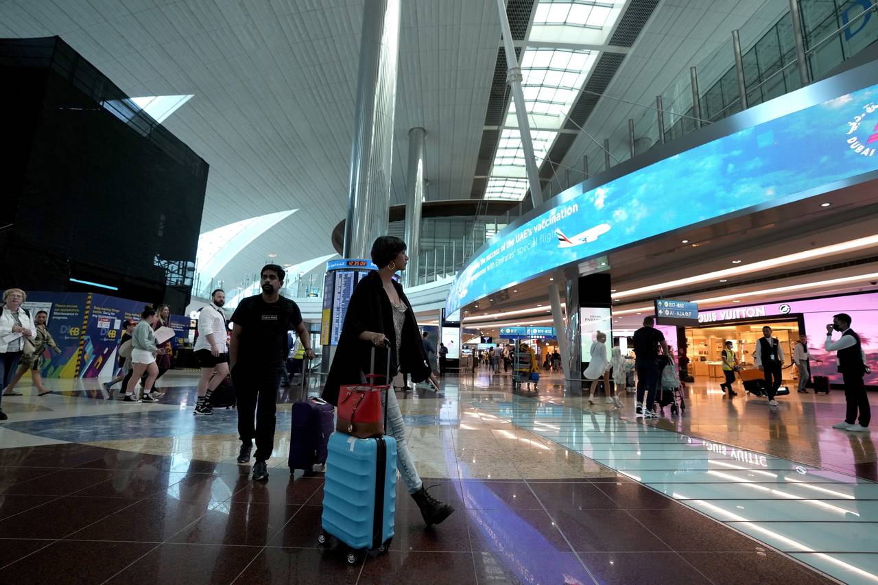 FILE - Passengers arrive at the Dubai Airport terminal 3, in Dubai, United Arab Emirates, on Oct. 2...