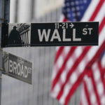 
              FILE - A street sign is seen in front of the New York Stock Exchange in New York, Tuesday, June 14, 2022. AP Photo/Seth Wenig, File)
            