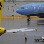 
              Workers direct airplanes on the wet tarmac at Fort Lauderdale-Hollywood International Airport as Tropical Storm Nicole threatens the east coast of Florida on Wednesday, Nov. 9, 2022.  (Amy Beth Bennett/South Florida Sun-Sentinel via AP)
            