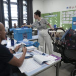 
              A woman votes during Israeli elections in Tel Aviv, Israel, Tuesday, Nov 1, 2022. (AP Photo/Oded Balilty)
            