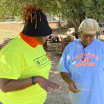 
              Erika Hardwick, left, a paid canvasser with the New Georgia Project Action Fund, shared literature with Patricia Lee urging Lee to vote on Wednesday, Oct. 5, 2022 in Dawson, Ga. Candidates, parties and outside groups are increasing their emphasis on door-to-door outreach as Georgia grows more politically competitive. (AP Photo/Jeff Amy)
            