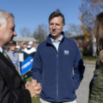 
              Rhode Island General Treasurer and Democratic candidate for the state's 2nd Congressional District, Seth Magaziner, center, and his wife, Julia McDowell, right, talk with Sen. Jack Reed, D-R.I., while greeting voters outside a polling site in Johnston, R.I., Tuesday, Nov. 8, 2022. (AP Photo/David Goldman)
            