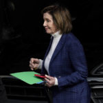 
              House Speaker Nancy Pelosi is escorted to a vehicle outside of her home in San Francisco, Friday, Nov. 4, 2022. (AP Photo/Jeff Chiu)
            