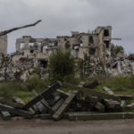 
              Ammunition boxes lay outside a destroyed school on the outskirts of a recently liberated village outskirts of Kherson, in southern Ukraine, Wednesday, Nov. 16, 2022. (AP Photo/Bernat Armangue)
            