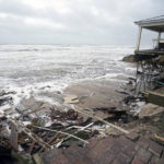 
              Parts of homes are seen collapsing on the beach due to the storm surge by Hurricane Nicole, Thursday, Nov. 10, 2022, in Wilbur-By-The-Sea, Fla. (AP Photo/John Raoux)
            