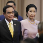 
              Thailand's Prime Minister Prayuth Chan-o-cha, left, and his wife Naraporn Chan-ocha arrive for the opening ceremony of the 40th and 41st ASEAN Summits (Association of Southeast Asian Nations) in Phnom Penh, Cambodia, Friday, Nov. 11, 2022. The ASEAN summit kicks off a series of three top-level meetings in Asia, with the Group of 20 summit in Bali to follow and then the Asia Pacific Economic Cooperation forum in Bangkok. (AP Photo/Vincent Thian)
            