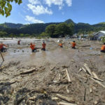 
              In this photo provided by the Philippine Coast Guard, rescuers continue their search for missing bodies at Barangay Kusiong, Datu Odin Sinsuat, Maguindanao province, southern Philippines on Monday, Oct. 31, 2022. Several people have died in one of the most destructive storms to lash the Philippines this year with dozens more feared missing after villagers were buried in a boulder-laden mudslide. (Philippine Coast Guard via AP)
            