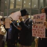 
              Protesters hold up white paper some with writings commemorating the Nov 24 deadly Urumqi fire during a gathering at the University of Hong Kong in Hong Kong, Tuesday, Nov. 29, 2022. On Tuesday, about a dozen people gathered at the University of Hong Kong, chanting against virus restrictions and holding up sheets of paper with critical slogans. Most were from the mainland, which has a separate legal system from the Chinese territory of Hong Kong, and some spectators joined in their chants. (AP Photo/Bertha Wang)
            