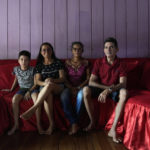
              Members of the fishing community, Antonio Moura Da Cunha, poses with his family, from left, grandchild Jonnathan Cunha Dos Santos, daughter Quilvilene Figueiredo Da Cunha and wife Irlene Das Gracas da Cunha Figueiredo in San Raimundo settlement, Carauari, at Medio Jurua Region, Amazonia State, Brazil, Sunday, Sept. 4, 2022. In Sao Raimundo region, there were 1,335 pirarucus in the nearby lakes in 2011, when the managed fishing began. Last year, there were 4,092 specimens, according to their records. (AP Photo/Jorge Saenz)
            