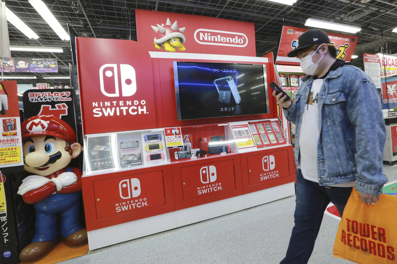 A man walks an advertisement of Nintendo Switch at an electronics retail chain store in Tokyo on Oc...