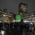 
              A Boston MBTA subway station is illuminated with green light following a ceremony attended by Britain's Prince William and Kate, Princess of Wales, Wednesday, Nov. 30, 2022, in Boston. The ceremony was held to highlight the Earthshot Prize and environmental issues. (AP Photo/Steven Senne)
            