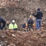 
              South African police investigate at the scene where more than 20 bodies, suspected of being illegal miners, were found near an active mine in Krugersdorp, South Africa, Thursday, Nov. 3, 2022. Police suspect that the bodies were moved to where they were found at a privately-owned mine. The grim discovery is the latest in a series of incidents related to illegal mining in the Krugersdorp area. (AP Photo)
            