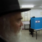 
              An Ultra-Orthodox Jewish man votes for Israel's parliamentary election at a polling station in Bnei Brak, Israel, Tuesday, Nov. 1, 2022. Israel is holding its fifth election in less than four years. (AP Photo/Oded Balilty)
            