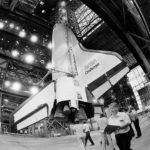 
              FILE - The space shuttle Challenger hangs suspended inside the Vehicle Assembly Building, April 10, 1985, as preparations are made to mate it with the booster rockets and external tank. On Thursday, Nov. 10, 2022, NASA announced that a large section of the destroyed spacecraft has been found buried in sand at the bottom of the Atlantic, more than three decades after the tragedy that killed a schoolteacher and six others. (AP Photo/Phil Sandlin, File)
            