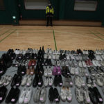 
              Shoes collected from the scene of a deadly accident following Saturday night's Halloween festivities, are placed at a temporary lost and found center at a gym in Seoul, South Korea, Tuesday, Nov. 1, 2022. Police have assembled the crumpled tennis shoes, loafers and Chuck Taylors, part of 1.5 tons of personal objects left by victims and survivors of the tragedy, in hopes that the owners, or their friends and family, will retrieve them. (AP Photo/Lee Jin-man)
            