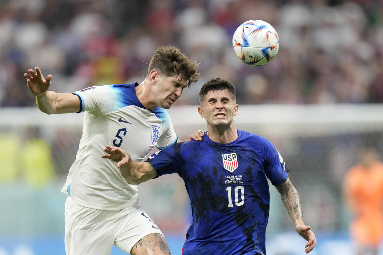 England's John Stones vies for the ball with Christian Pulisic of the United States, right, during ...