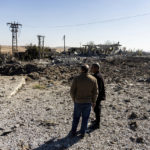 
              People look at a site damaged by Turkish airstrikes that hit an electricity station in the village of Taql Baql, in Hasakeh province, Syria, Sunday, Nov. 20, 2022. The Turkish Defense Ministry said Sunday that Turkey launched deadly airstrikes over northern regions of Syria and Iraq, targeting Kurdish groups that Ankara holds responsible for last week's deadly bomb attack in a bustling street in Istanbul. (AP Photo/Baderkhan Ahmad)
            