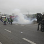 
              Riot police launch teargas at truckers blocking a highway in protest against President Jair Bolsonaro's loss in the country's presidential runoff election, in Embu das Artes, on the outskirts of Sao Paulo, Brazil, Tuesday, Nov. 1, 2022.  Since the former President Luiz Inacio Lula da Silva's victory Sunday night, many truck drivers have jammed traffic in areas across the country and said they won’t acknowledge Bolsonaro’s defeat. Bolsonaro hasn’t spoken publicly since official results were released roughly 36 hours ago, nor phoned da Silva to concede. (AP Photo/Andre Penner)
            