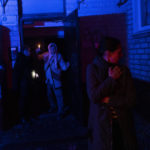 
              Residents stand outside a building that was shelled during a Russian attack in Kherson, southern Ukraine, Thursday, Nov. 24, 2022. (AP Photo/Bernat Armangue)
            
