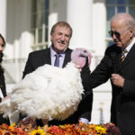 
              President Joe Biden pardons Chocolate, the national Thanksgiving turkey, at the White House in Washington, Monday, Nov. 21, 2022. Biden is joined by, Ronald Parker, Chairman of the National Turkey Federation, and Alexa Starnes, daughter of the owner of Circle S Ranch. (AP Photo/Andrew Harnik)
            