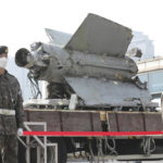 
              South Korean army soldiers stand in front of the debris of a missile which the Defense Ministry identified as a North Korea's SA-5 surface-to-air missile according to South Korea's military, at the Defense Ministry in Seoul, South Korea, Wednesday, Nov. 9, 2022. South Korea says the recovered debris of a North Korean missile fired toward the South amid a barrage of sea launches last week was determined to be a Soviet-era anti-aircraft weapon that dates back to the 1960s. (Han Sang-kyun/Yonhap via AP)
            