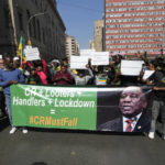 
              FILE — African National Congress (ANC) members protest outside the party's headquarters at Luthuli House in Johannesburg, South Africa, Friday, July 15, 2022, to demand action be taken against President Cyril Ramaphosa over his Phala Phala farm saga. Ramaphosa is facing serious calls to step down after a parliamentary probe found he may have breached the country's anti-corruption laws related to the theft of millions of dollars at his Phala Phala game farm.(AP Photo/Themba Hadebe/File)
            