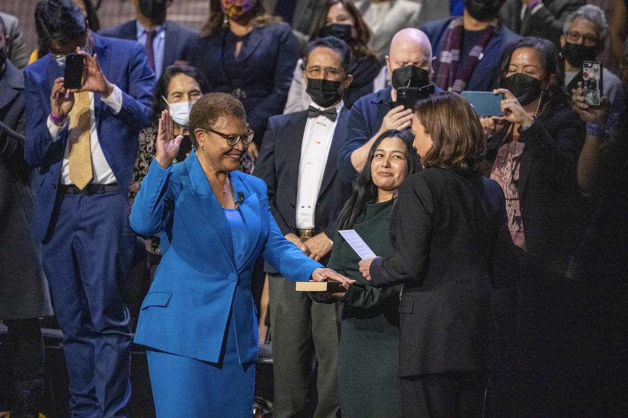 Karen Bass, left, is sworn in as mayor of Los Angeles by Vice President Kamala Harris, a longtime f...