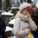 
              A woman reacts during the funeral ceremony of Daniel Sztyber, a 35-year-old man from Warsaw who died fighting in Ukraine, at the Powazki Cemetery in Warsaw, Poland, Tuesday, Dec. 20, 2022. (AP Photo/Michal Dyjuk)
            