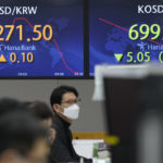 
              A currency trader watches computer monitors near the screens showing the foreign exchange rate between U.S. dollar and South Korean won at a foreign exchange dealing room in Seoul, South Korea, Wednesday, Dec. 28, 2022. Shares were mixed in Asia on Wednesday after a post-holiday retreat on Wall Street, as markets count down to the end of a painful year for investors.(AP Photo/Lee Jin-man)
            