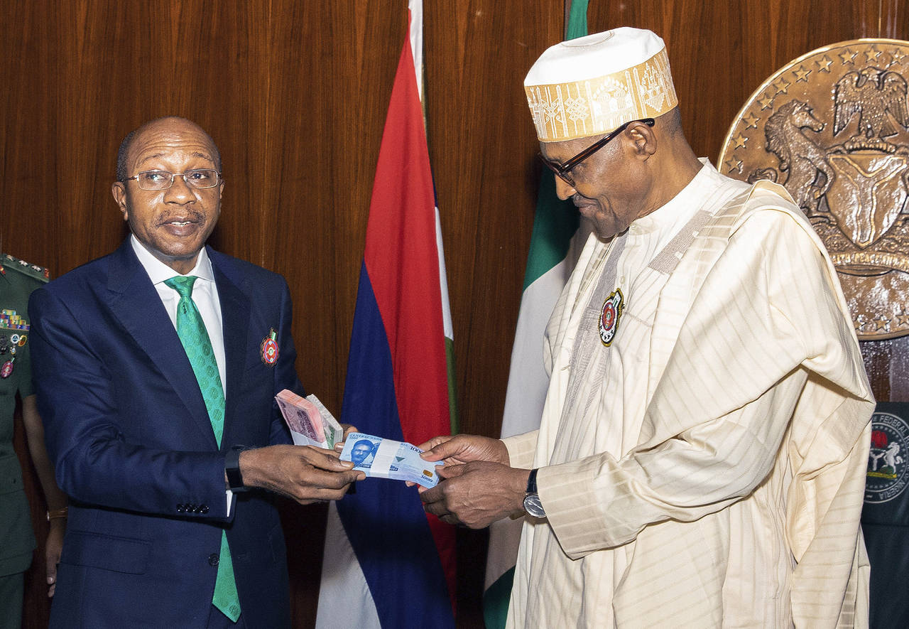 In this photo released by the Nigeria State House, Nigeria's central bank governor, Godwin Emefile,...