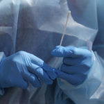 
              FILE - A nurse gives a COVID-19 test outside the Salt Lake County Health Department Friday, July 22, 2022, in Salt Lake City.  On Friday, Dec. 9, 2022, The Associated Press reported on stories circulating online incorrectly claiming a COVID-19 test patent application is dated 2020 but was actually filed in 2015. (AP Photo/Rick Bowmer, File)
            