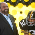 
              FILE - Former Pittsburgh Steelers running back Franco Harris stands next a statute of himself on Sept. 12, 2019, at Pittsburgh International Airport near Pittsburgh. (Nate Guidry/Pittsburgh Post-Gazette via AP, File)
            