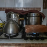 
              A fire-resistant brick heats on the stove in Larysa Shevtsova's home in in Kherson, Ukraine as the family tries to warm the house on Nov. 26, 2022. When the rectangular block was hot enough, it was carried carefully into the living room and set on top of a Soviet-era space heater that no longer worked. Shevtsova, her husband and two sons, one of them three years old, huddled around the brick for warmth that would last for about 30 minutes. “We use this method to heat the room,” Shevtsova said. “Before that we just froze.” (AP Photo/Sam Mednick)
            